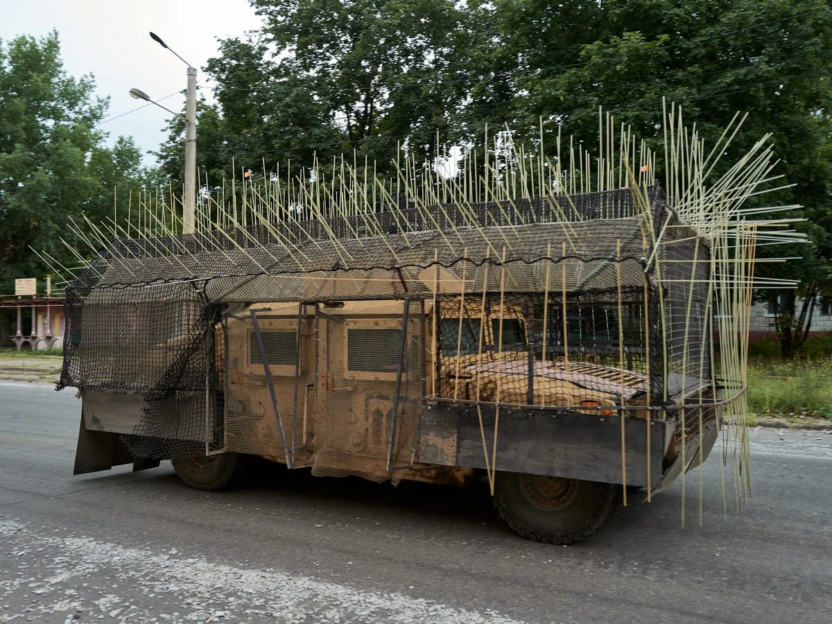 Drone cage armor being mounted on armored vehicle turret