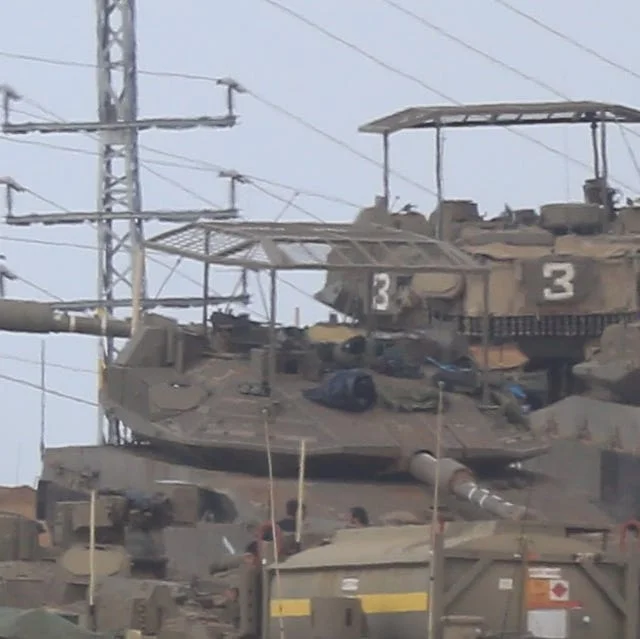 Tank with cope cage armor on battlefield